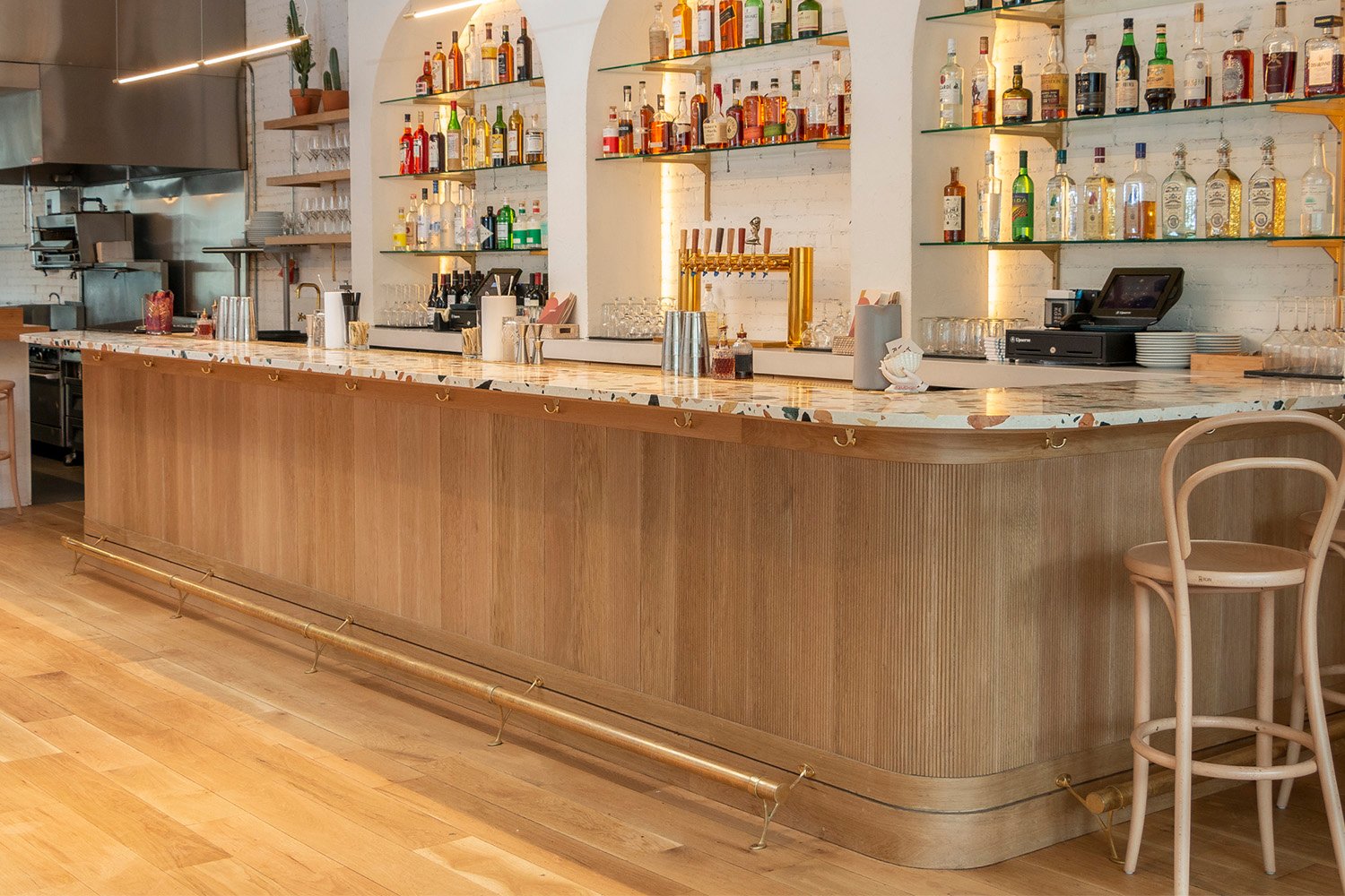 polished brass bar rail installed at a bar