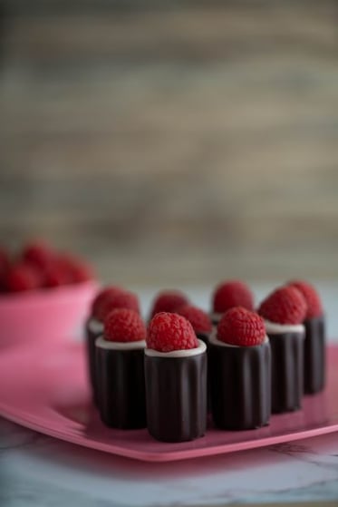 Boozy Raspberry Chocolate Cups on a heart plate.