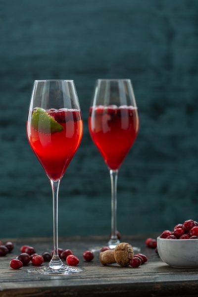 Cranberry Champagne Cocktail with bowl of cranberries
