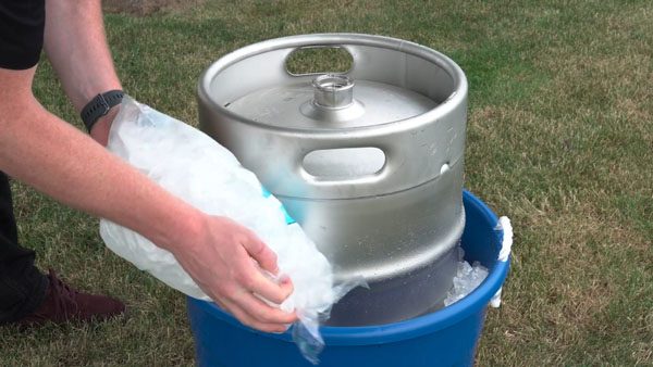filling an ice bucket to chill a keg
