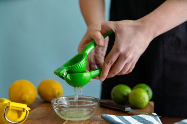 Juicer squeezing a lime